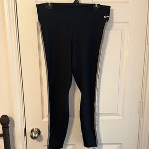 Nike Women’s Black Leggings with logo down side of legs. Size XL